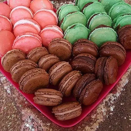 A heart-shaped tray of macarons