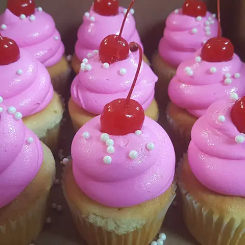 Pink cupcakes with cherries