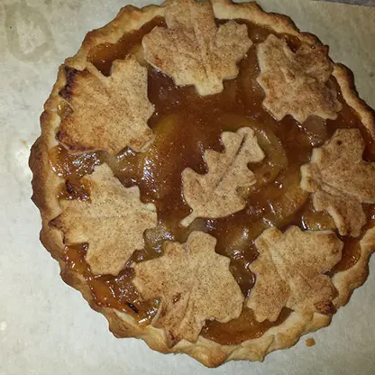 An apple pie with leaf-shaped crust