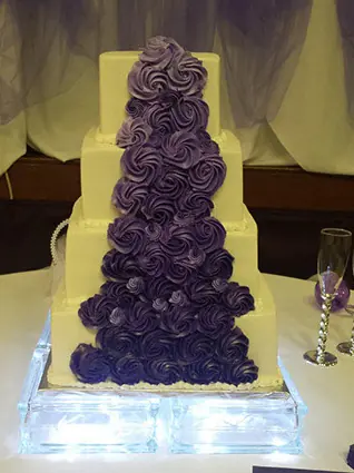 A tall purple ombre rosette cake